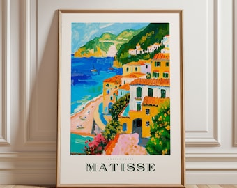 May include: A framed art print of a coastal scene in the style of Matisse. The artwork depicts colorful buildings with orange roofs along a blue coastline. The print includes the text "MATISSE" and "AMALFI COAST".