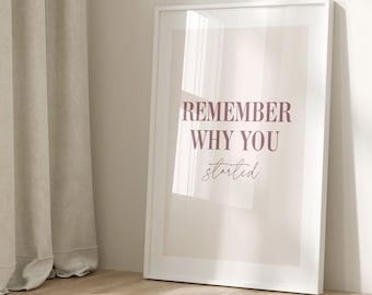 May include: A white framed poster with a light pink background and the text "REMEMBER WHY YOU started" in a dark pink font.