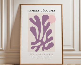 May include: A framed art print featuring a minimalist design with a large, abstract purple shape and a pink cloud-like form on a beige background. The text "PAPIERS DÉCOUPÉS" and "BERGGRUEN & CIE" are printed at the top and bottom, respectively.