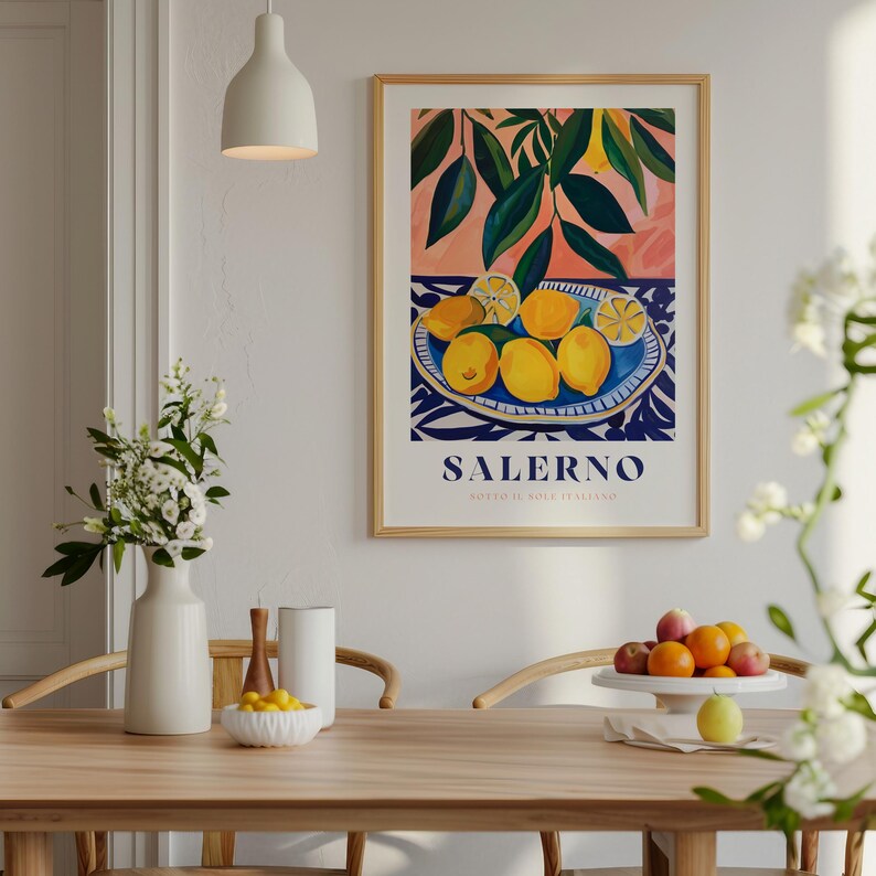 May include: A framed print with a colorful illustration of lemons in a blue and white bowl. The print has the text "SALERNO" and "SOUTHERN ITALY" in a white font.