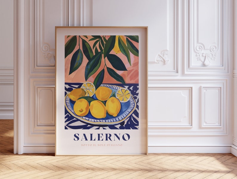 May include: A framed poster with a colorful illustration of lemons in a blue and white patterned bowl. The poster has the text "SALERNO SOTTO IL SOLE ITALIANO" at the bottom.