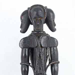 African wooden statue from Ivory Coast. 1970 circa, vintage. Fang People. Three-heads votive statue / religious primitive statue