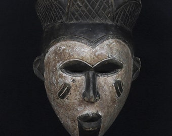 African mask from Congo.  Punu Okuyi people.  Africa, 1970 circa. White wooden spirit mask.