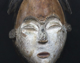 African mask from Congo.  Punu Okuyi people.  Africa, 1970 circa. White wooden spirit mask.