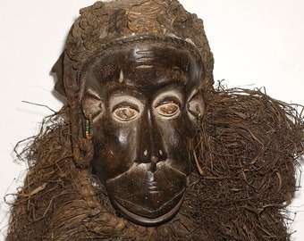 African mask from Cameroon. Bulu mask in monkey Shape with raffia, fabric and cord. 1950 circa.