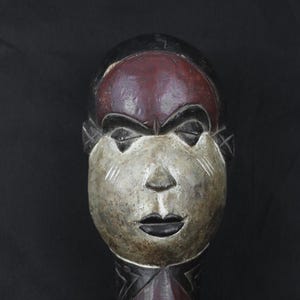 African mask from Congo. Bakongo people 1970 AD. Wooden mask. Red White pigmentation