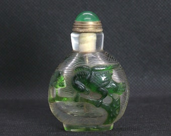 Chinese snuff bottle. Vintage, China. 1970 circa. Handmade glass snuff bottle, with green decorations.