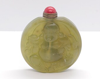 China. 1950 circa. Handcarved hardstone snuff bottle with Buddha and Tao Chi encarved.