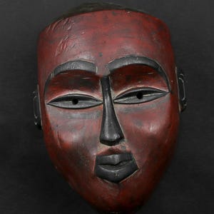 African mask from Congo. Bakongo tribe. 1970 AD. Wooden mask. Red White pigmentation