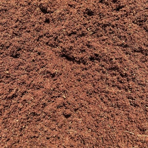 May include: Close-up of a pile of brown coconut coir, a natural fiber used for gardening and potting.
