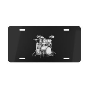 May include: Black and white illustration of a drum set on a black background. The drum set is made up of a bass drum, a snare drum, two toms, and a cymbal.
