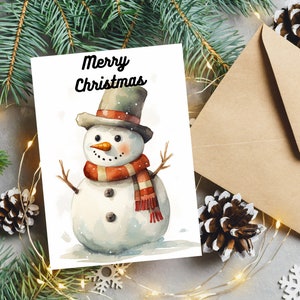 Puede incluir: Una ilustraci&oacute;n de acuarela de un mu&ntilde;eco de nieve con un sombrero de copa negro con una banda roja y blanca, una bufanda roja y una nariz de zanahoria. El texto "Merry Christmas" est&aacute; escrito encima del mu&ntilde;eco de nieve.