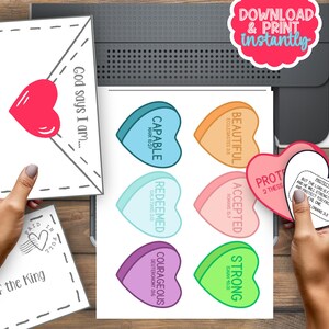 May include: Printable Valentine's Day cards with heart-shaped designs and Bible verses. The cards feature phrases like "God says I am..." and "Capable", "Beautiful", "Accepted", "Protected", "Redeemed", "Courageous", and "Strong".