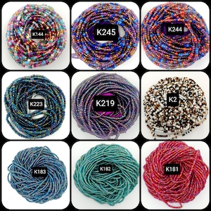 May include: Nine different strands of colorful glass beads, each wound into a circle. The beads are iridescent and have a variety of colors, including blue, green, purple, red, and white. Each strand is labeled with a code, such as "K245" and "K183".