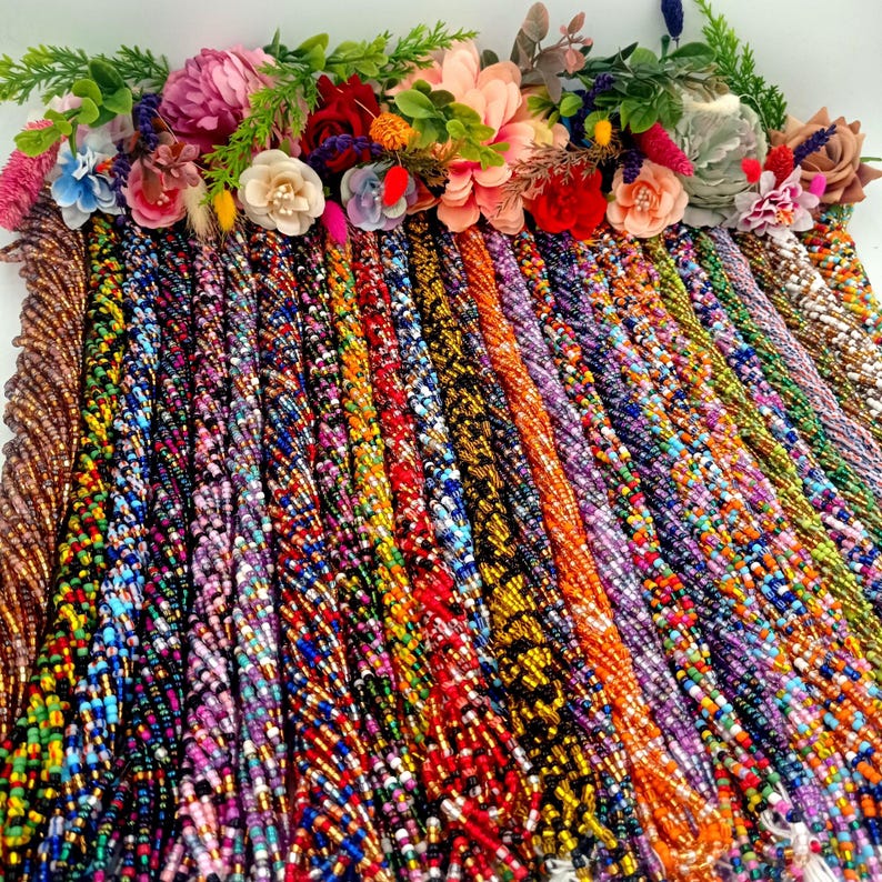 May include: A collection of colorful beaded strands, each with a unique pattern and color combination. The strands are arranged in rows, creating a vibrant and textured display.