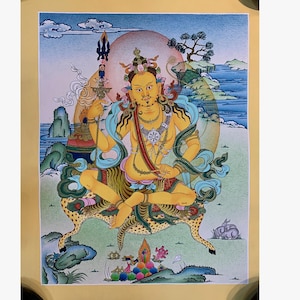 May include: A colorful painting of a seated figure with a yellow complexion, adorned with jewelry and a crown. The figure is surrounded by a halo and seated on a leopard-skin patterned cushion. The background features a landscape with mountains, water, and a tree.