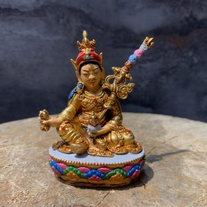 colorful Guru padmasambhava statue. copper statue. hand made statue. guru rinpoche. face painted.