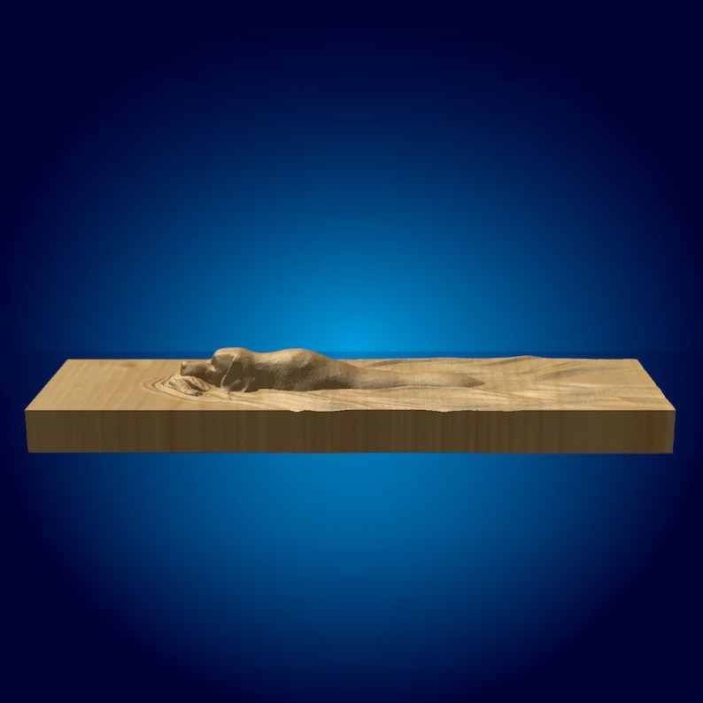 May include: A wooden block with a carved dog design. The dog is lying down with its head turned to the side. The block is a light brown color.