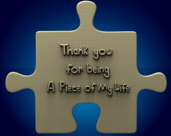 May include: A brown puzzle piece with the text "Thank you for being A Piece of My Life" on it.