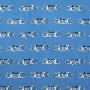 May include: A blue fabric with a repeating pattern of the Orlando Magic logo. The logo includes the team name, a basketball, and a star. The design is in white and blue.