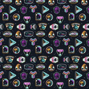 May include: Dark navy fabric with a repeating pattern of colorful space-themed emblems. The design includes geometric shapes, starships, and the text "ZAP", "STAR COMMAND", and "XLIS" in various colors like teal, purple, and gold.