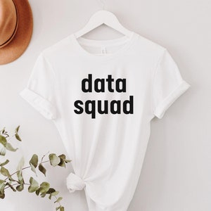 May include: White t-shirt with black text that reads "data squad".
