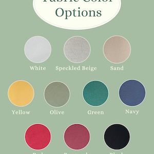 K&ouml;nnte beinhalten: Ein Bild mit Stofffarboptionen. Der Hintergrund ist hellgr&uuml;n, mit einem wei&szlig;en Oval mit dem Text "Fabric Color Options". Darunter sind neun Farbfelder: Wei&szlig;, gesprenkeltes Beige, Sand, Gelb, Olive, Gr&uuml;n, Marine, Rot, Burgunderrot und Schwarz.