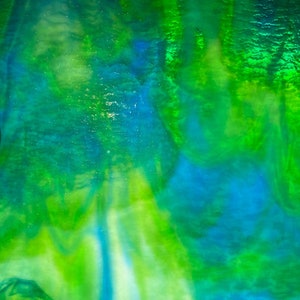 May include: Abstract artwork with a vibrant blend of colors. The image features a mix of green and blue hues, creating a dynamic and fluid visual effect. The colors appear to blend and swirl, suggesting a sense of depth and movement. The overall effect is one of energy and visual interest.
