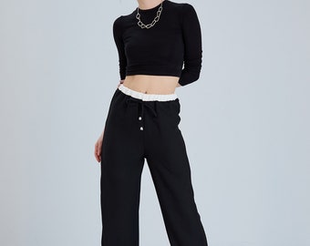 Contrasting black linen pants. High waist, palazzo, contrast, linen blend, pants. Casual trousers, relaxed fit, contrast, lace-up detail.