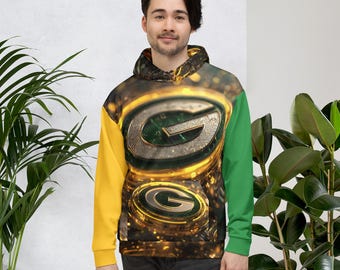 May include: A hooded sweatshirt with a vibrant design featuring the letter "G" in a metallic green and gold colour scheme. The sleeves are coloured yellow and green. The overall design has a digital, glowing effect.