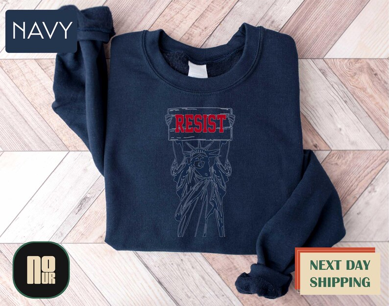 a navy sweatshirt with a drawing of a demon on it