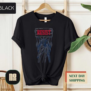 a black t - shirt with the words resist on it