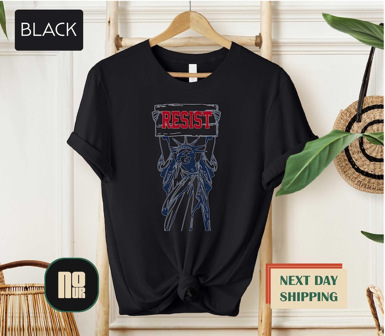 a black t - shirt with the words resist on it