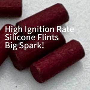 May include: A collection of small, cylindrical, dark red silicone flints with a textured surface. The text "High Ignition Rate Silicone Flints Big Spark!" is overlaid in white on the image, describing the functional nature of these items.