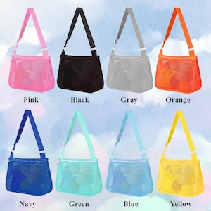 May include: A collection of mesh tote bags in various colors, including pink, black, gray, orange, navy, green, blue, and yellow. Each bag has a matching adjustable strap and contains several round objects. The bags are labeled with their respective colors.