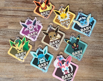 May include: Nine colorful car window signs featuring different Pokemon characters with the text "Baby on Board".