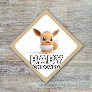 May include: A diamond-shaped "Baby on Board" sign featuring a cartoon Eevee character. The Eevee figure is tan with large eyes, a white ruff, and a fluffy tail. The sign has a tan border and is set against a wood-grain background.