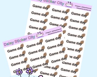 May include: Two sticker sheets with the text "Game day" and football graphics. The stickers are white with black text and brown footballs. The brand name "Daisy Sticker City" is at the top of the sheets.