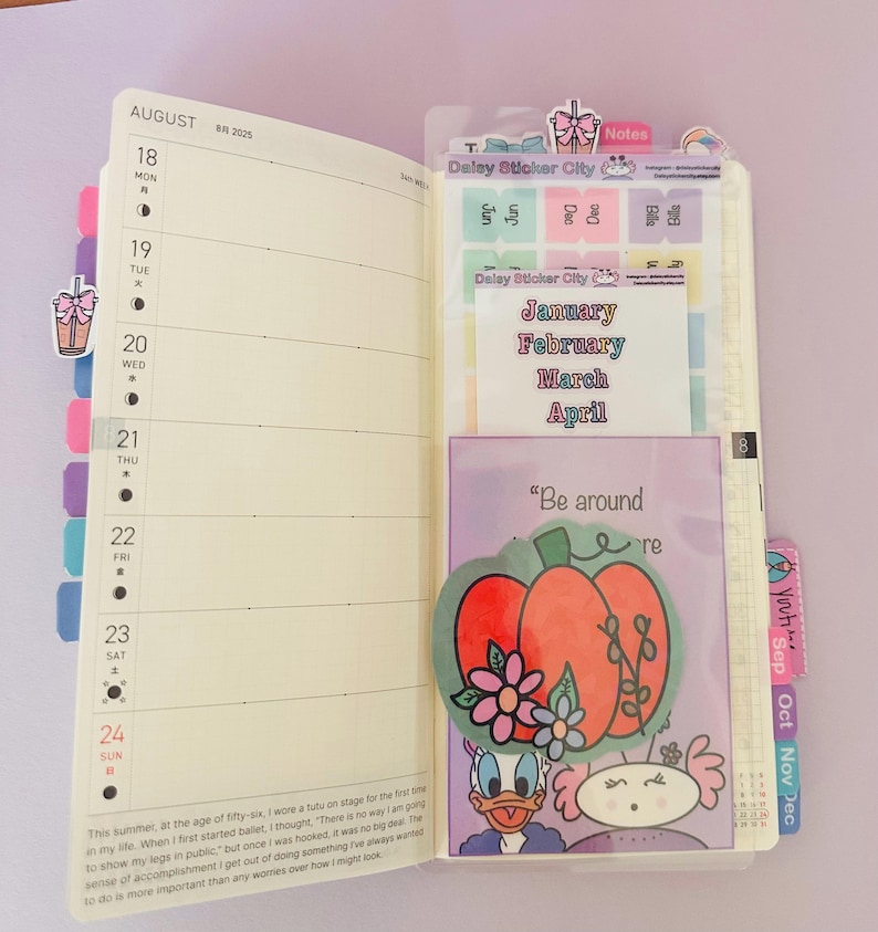 May include: Open planner with August calendar, stickers, and a pocket featuring a pumpkin illustration with flowers and the text "Be around re". Includes stickers from "Delay Sticker City" and month labels.