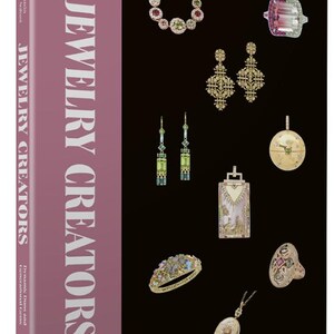 May include: A hardcover book titled Jewelry Creators by Beth Bernstein and Sonia Esther Soltani. The cover features a mauve spine with white text and a black front panel displaying various pieces of jewelry, including rings, earrings, and pendants.
