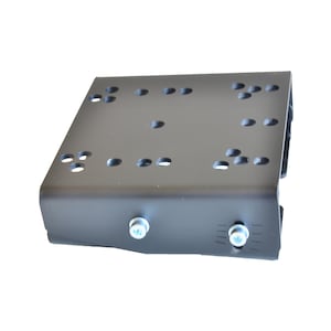May include: A matte black metal mounting bracket featuring a flat rectangular top surface with multiple circular pre-drilled holes arranged in clusters. The front vertical edge includes two silver-colored cylindrical bolts with hex heads.
