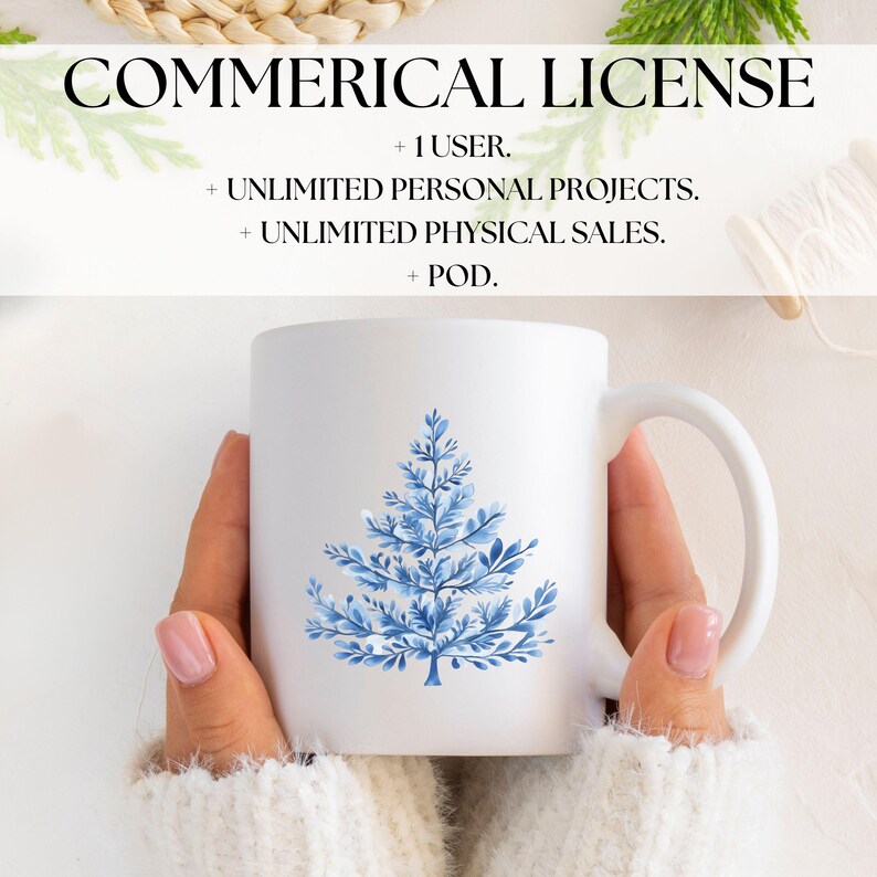 May include: A white ceramic mug with a blue watercolor illustration of a stylized Christmas tree. The mug is being held by a person wearing a white sweater.