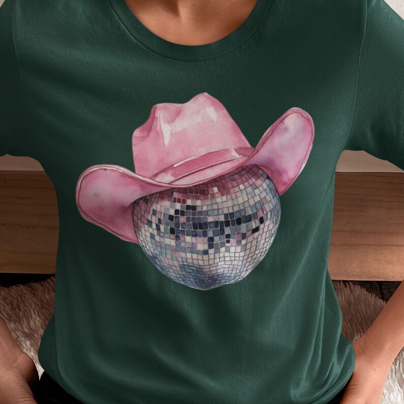 May include: A green t-shirt with a pink cowboy hat and a silver disco ball.