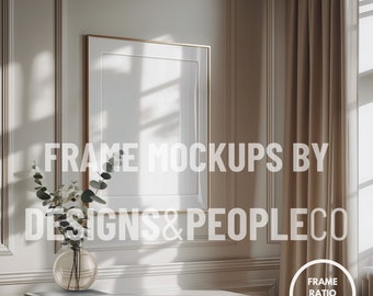 May include: A gold framed picture mockup in a room with white walls and a brown curtain. The frame is empty and there is a vase with green leaves on a white table in the foreground. The text "FRAME MOCKUPS BY DESIGNS & PEOPLECO" is visible in the image. The text "FRAME RATIO 2:3" is visible in a circle in the lower right corner of the image.