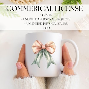 May include: White ceramic mug featuring a watercolor bow design in peach and sage green. The mug has the text "COMMERICAL LICENSE" and other text about usage rights. The mug is held by a person wearing a white sweater.
