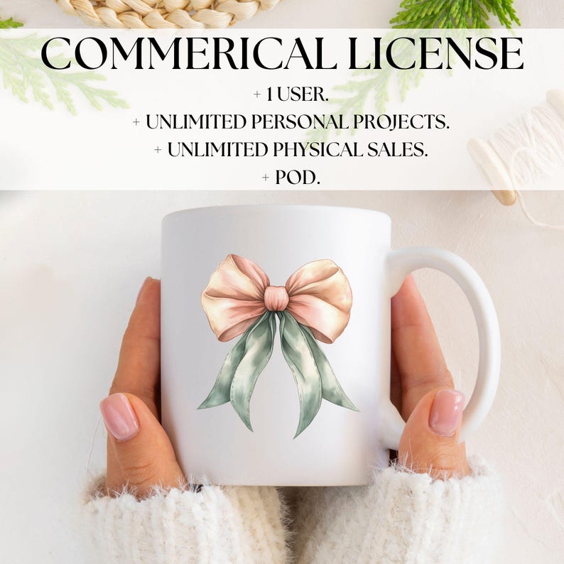 May include: White ceramic mug featuring a watercolor bow design in peach and sage green. The mug has the text "COMMERICAL LICENSE" and other text about usage rights. The mug is held by a person wearing a white sweater.