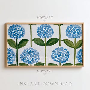 May include: A framed print featuring a repeating pattern of blue hydrangea flowers with green leaves and stems against a white background. The frame is a light wood color. The text "MOVART" and "INSTANT DOWNLOAD" are visible.