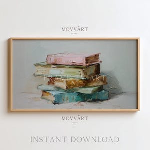 May include: A framed art print featuring a stack of books in a still life painting style. The books are in shades of pink, green, and blue, with visible brushstrokes. The text "MOVvART" and "INSTANT DOWNLOAD" are also visible.
