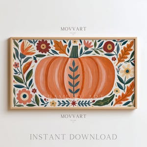 May include: A rectangular framed digital art print featuring a large central orange pumpkin decorated with a blue leaf pattern. The pumpkin is surrounded by a border of stylized flowers and orange leaves in shades of red, blue, and yellow.