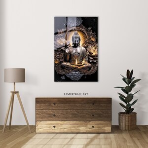 May include: A golden Buddha statue sits in a meditative pose surrounded by lotus flowers and a glowing light. The statue is set against a black background with a subtle sparkle effect.